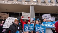 Protestors gather during a demonstration at the headquarters of the Department of Education, Friday, March 14, 2025, in Washington. (AP Photo/Mark Schiefelbein)