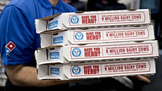 An employee moves pizza boxes before a delivery at a Domino’s Pizza restaurant in Chantilly, Virginia.