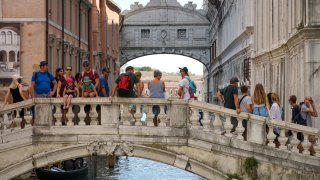 Tourists look at the Bridge of Sighs in Venice, Italy, on Aug. 25, 2021.