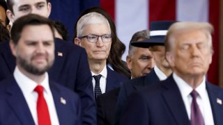Apple CEO Tim Cook, center, watches during the inauguration ceremonies for President Donald Trump, right, and Vice President JD Vance, left, in the rotunda of the U.S. Capitol in Washington, Jan. 20, 2025.