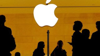Customers walk past an Apple logo inside of an Apple store at Grand Central Station in New York on Aug 1, 2018.