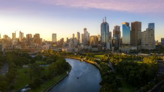 Sunset view of Yarra river and Melbourne skyscrapers business office building with evening skyline in Victoria, Australia.