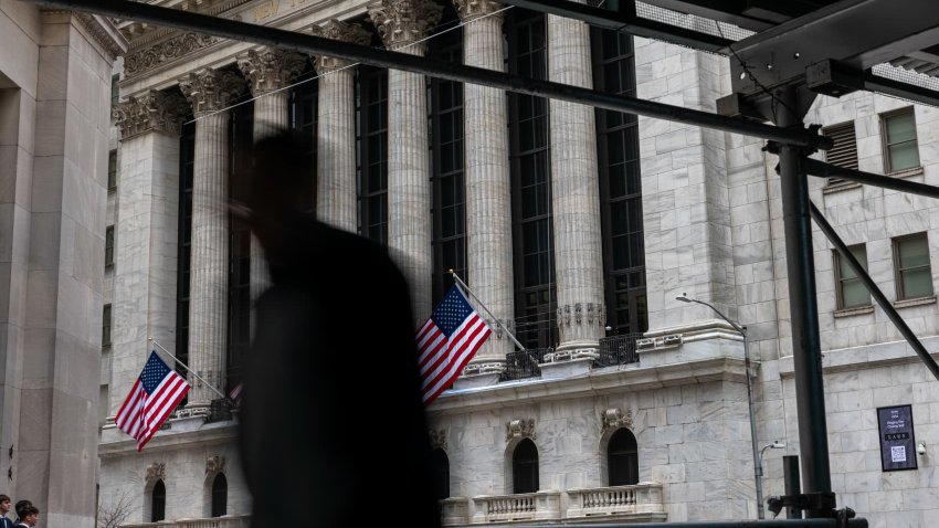 People walk by the New York Stock Exchange (NYSE) before the Closing Bell and the start of President Donald Trump’s news conference on tariffs on April 2, 2025 in New York City. 