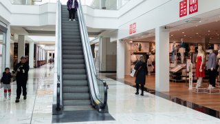 Shoppers walk past Uniqlo store in King of Prussia Mall, as global markets brace for a hit to trade and growth caused by U.S. President Donald Trump’s decision to impose import tariffs on dozens of countries, in King of Prussia, Pennsylvania, U.S., April 3, 2025.
