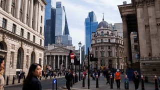 Workers cross a junction near the Bank of England (BOE) in the City of London, UK, on Tuesday, April 8, 2025.