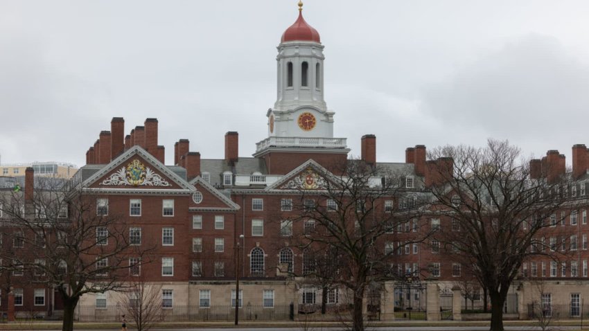 A person runs past Dunster House at Harvard University in Cambridge, Massachusetts, March 17, 2025.