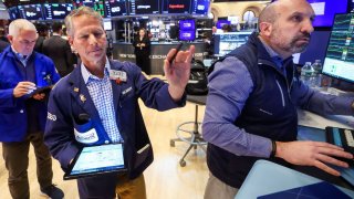 Traders work on the floor at the New York Stock Exchange on April 17, 2025.