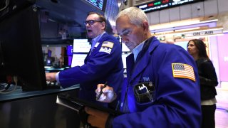 Traders work on the floor of the New York Stock Exchange at the opening bell in New York City, on April 17, 2025.