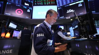 A trader works on the floor of the New York Stock Exchange at the opening bell in New York City, on April 17, 2025.