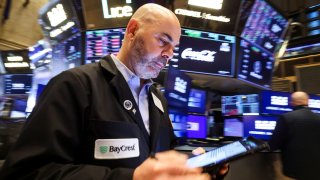 Traders work on the floor at the New York Stock Exchange (NYSE) in New York City, U.S., April 21, 2025.