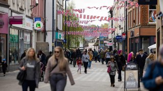 Shoppers pass along the high street in Maidstone, UK, on Wednesday, April 16, 2025.
