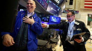 Traders work on the floor at the New York Stock Exchange on April 22, 2025.