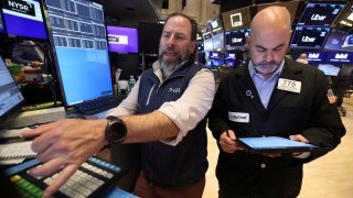 Traders work on the floor at the New York Stock Exchange on April 24, 2025.