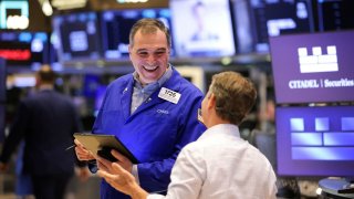 Traders work on the floor at the New York Stock Exchange on April 28, 2025.