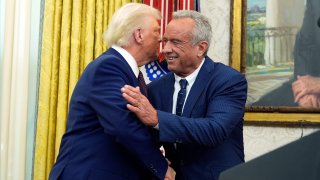 President Donald Trump congratulates Robert F. Kennedy Jr., after he was sworn in as Health and Human Services Secretary in the Oval Office at the White House, Thursday, Feb. 13, 2025, in Washington.