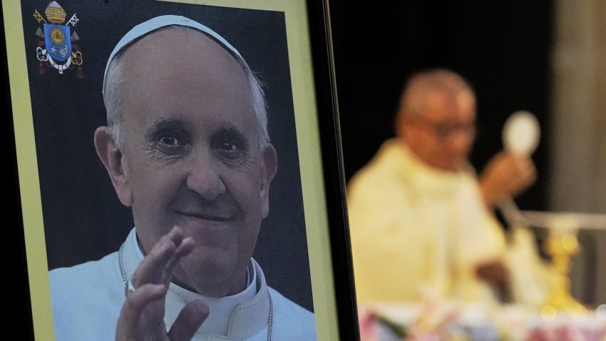 A photo of the late Pope Francis stands in front of Father Francisco Javier during a Mass in his honor at the Metropolitan Cathedral in Mexico City, Monday, April 21, 2025.