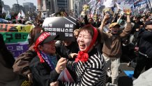 South Koreans react after hearing the Constitutional Court's verdict