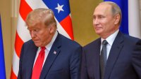 Donald Trump (L) and Russia’s Vladimir Putin arrive to attend a joint press conference after a meeting at the Presidential Palace in Helsinki, on July 16, 2018. 