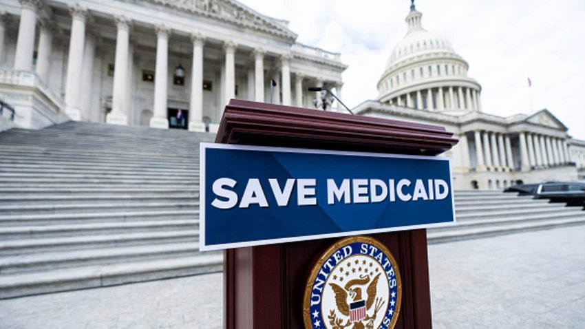 A “Save Medicaid” sign is affixed to the podium for the House Democrats’ press event to oppose the Republicans’ budget on the House steps of the Capitol on Tuesday, February 25, 2024. 