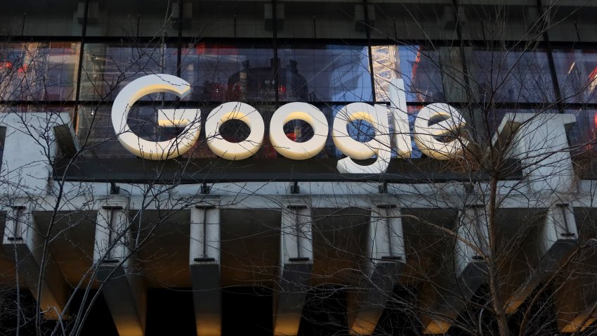 A Google corporate logo hangs above the entrance to the company’s office at St. John’s Terminal in New York City on March 11, 2025.