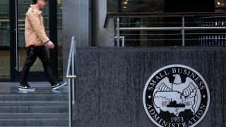 People walk past the headquarters of the U.S. Small Business Administration in the Southwest Federal Center area on March 24, 2025 in Washington, DC.