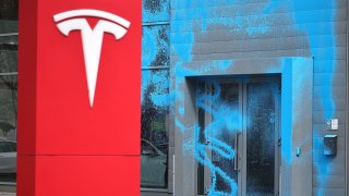 A Tesla car showroom stands doused in blue paint following vandalism by activists of the group New Generation on March 31, 2025 in Berlin, Germany.
