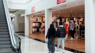 Shoppers walk past Uniqlo store in King of Prussia Mall, as global markets brace for a hit to trade and growth caused by U.S. President Donald Trump’s decision to impose import tariffs on dozens of countries, in King of Prussia, Pennsylvania, U.S., April 3, 2025.