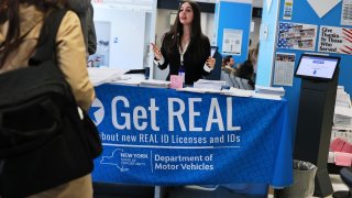An employee checks people in at the New York State DMV on April 28, 2025 in New York City.