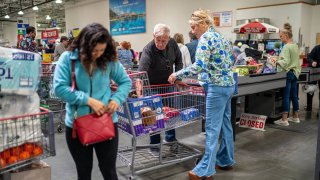 Customers line up at the check out booth on April 18, 2025 at a Costco branch in Niantic, Connecticut.