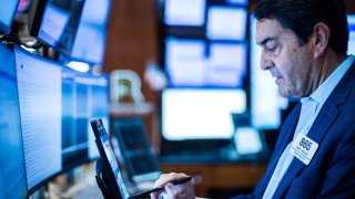 Traders work on the floor of the New York Stock Exchange on May 1, 2025.