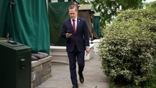 National Security Advisor Michael Waltz looks at his phone as he prepares for a TV interview at the White House on May 01, 2025 in Washington, DC.