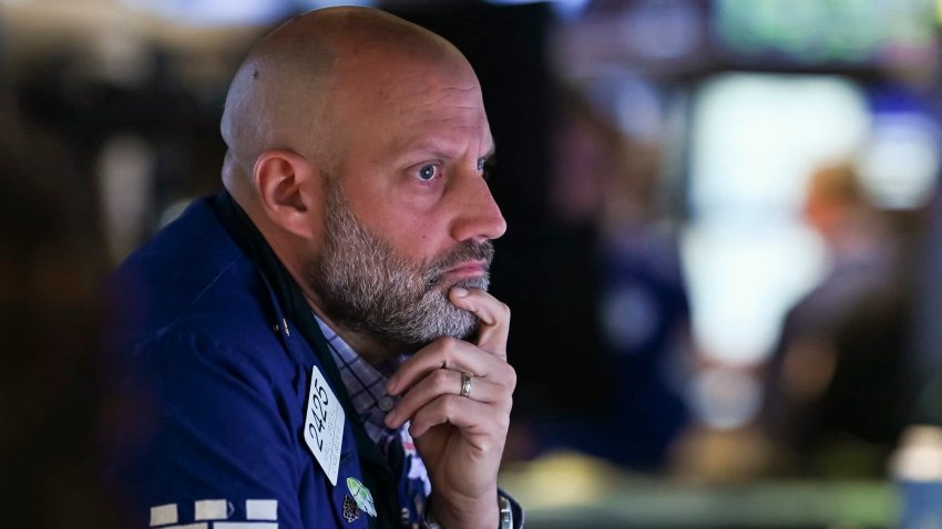 Traders work on the floor of the New York Stock Exchange at the opening bell on May 12, 2025.