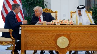 U.S. President Donald Trump, Qatar’s Emir Tamim bin Hamad Al Thani and Boeing CEO Kelly Ortberg attend a signing ceremony in Doha, Qatar, on May 14, 2025.