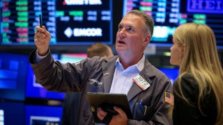 Traders work on the floor at the New York Stock Exchange on May 14, 2025.