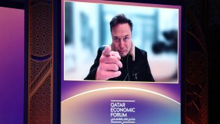 Elon Musk, chief executive officer of Tesla Inc., speaks via video link at the Qatar Economic Forum (QEF) in Doha, Qatar, on Tuesday, May 20, 2025.