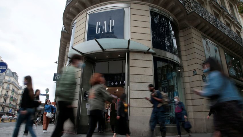 People walk past the entrance of a Gap store in Paris, France, July 1, 2021.