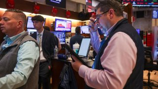 Traders work on the floor of the New York Stock Exchange on May 21, 2025 in New York City.