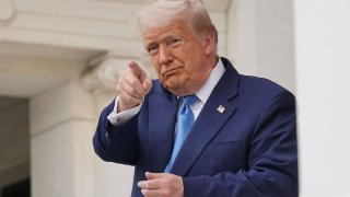 U.S. President Donald Trump gestures at the annual National Memorial Day Observance in the Memorial Amphitheater, at Arlington National Cemetery in Arlington, Virginia, U.S., May 26, 2025.