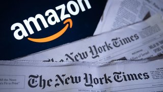 This photo illustration shows print editions of The New York Times and the Amazon logo in Washington, DC, on May 29, 2025.