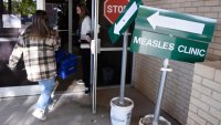 FILE – Health department staff members enter the Andrews County Health Department measles clinic carrying doses of the measles, mumps and rubella vaccine, Tuesday, April 8, 2025, in Andrews, Texas.