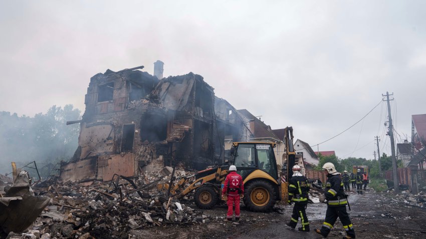 Rescuers work on a site after a Russian strike on residential neighbourhood in Markhalivka village, Kyiv region, Ukraine, Sunday, May 25, 2025. (AP Photo/Evgeniy Maloletka)