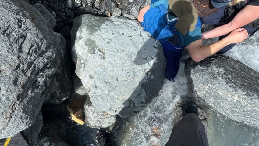 Kell Morris, upper right in a brown hat, trapped under a 700 pound rock