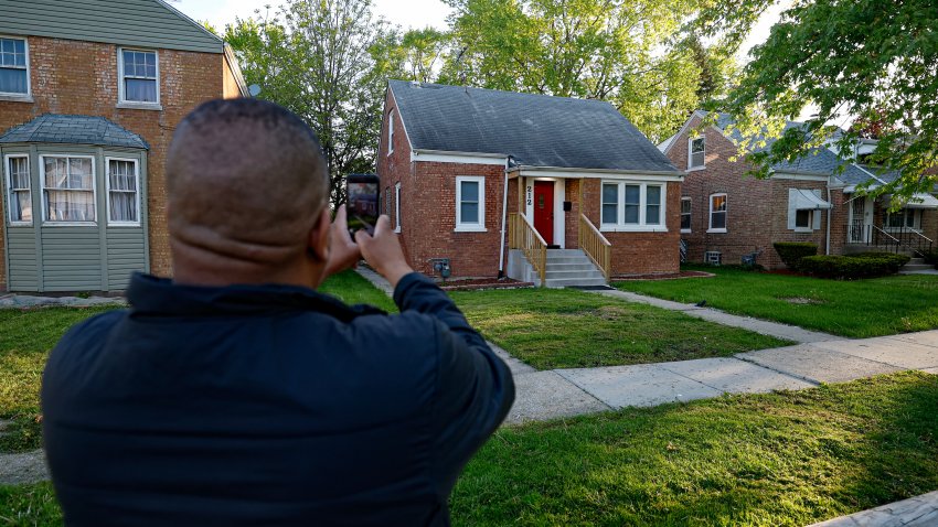 A person takes a picture of the childhood home of the new Pope Leo XIV in Dolton, Illinois, on May 9, 2025. Robert Francis Prevost became the first pope from the United States on May 8, 2025, picking the papal name Leo XIV after cardinals from around the world elected him leader of the world’s 1.4 billion Catholics. Tens of thousands of people packed in St Peter’s Square cheered as Prevost appeared on the balcony of St Peter’s Basilica, waving with both hands, smiling and bowing. (Photo by KAMIL KRZACZYNSKI / AFP) (Photo by KAMIL KRZACZYNSKI/AFP via Getty Images)