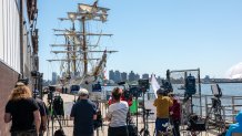 NEW YORK, NEW YORK - MAY 19: Media gather near a damaged Mexican Navy sailing ship, the Cuauhtémoc, that crashed into the Brooklyn Bridge over the weekend as it sits moored in lower Manhattan on May 19, 2025 in New York City. The collision, which snapped all three of the masts on the ship as it collided with the landmark bridge, killed at least two crew members and injured 19 others. (Photo by Spencer Platt/Getty Images)