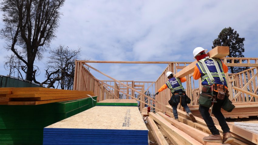PALISADES, CA  – APRIL 24,  2025 – – Workers carry lumber while helping to construct the first home to be rebuilt in the fire zone at 15256 De Pauw Street in Pacific Palisades on April 15, 2026.  Dolan Design are overseeing construction of the new home. (Genaro Molina/Los Angeles Times via Getty Images)
