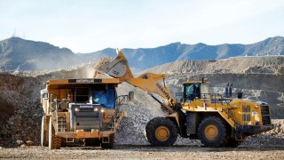 A wheel loader operator fills a truck with ore at the MP Materials rare earth mine in Mountain Pass, California, January 30, 2020.