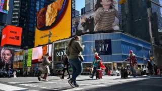 Old Navy and Gap retail stores are seen as people walk through Times Square in New York City on April 9, 2025.