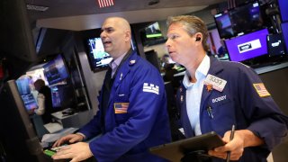 Traders work on the floor at the New York Stock Exchange (NYSE) in New York City, U.S., June 4, 2025.
