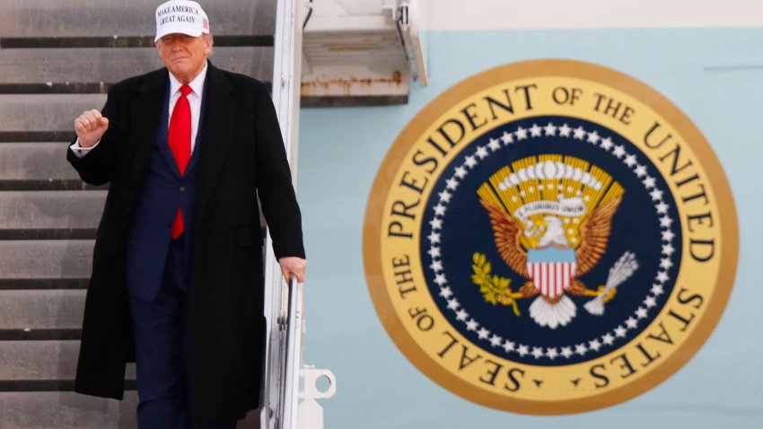 U.S. President Donald Trump raises a fist as he steps off of Air Force One upon arrival at Calgary International Airport, before the start of the G7 summit, in Alberta, Canada, June 15, 2025.