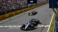 Mercedes' British driver George Russell crosses the finish line